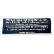 Sign - English & Spanish - We are not a fast food restaurant Please Be Patient