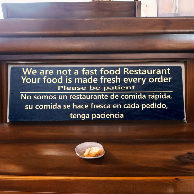 Sign - English & Spanish - We are not a fast food restaurant Please Be Patient