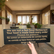 Sign - English & Spanish - We are not a fast food restaurant Please Be Patient