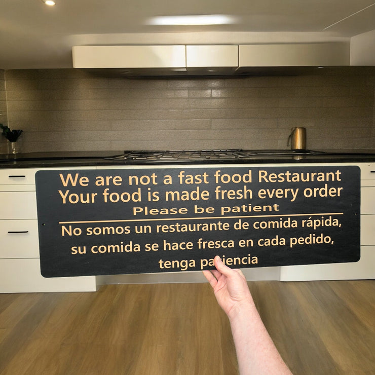 Sign - English & Spanish - We are not a fast food restaurant Please Be Patient